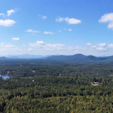 aerial view of forest and mountains and water