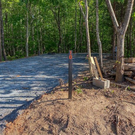 gravel RV site in wooded setting