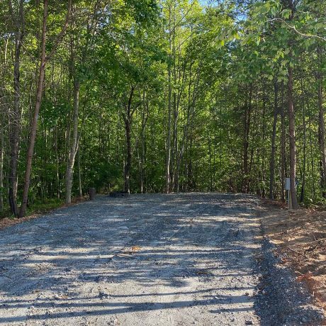 gravel RV site in wooded setting